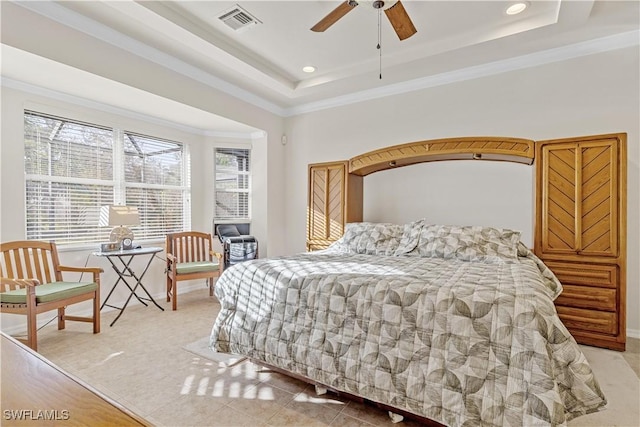 bedroom with a tray ceiling, ceiling fan, and crown molding