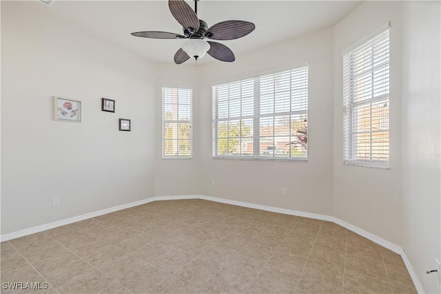 spare room with plenty of natural light and ceiling fan