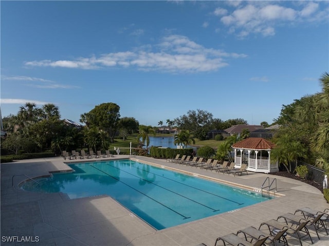 view of swimming pool featuring a gazebo, a patio area, and a water view