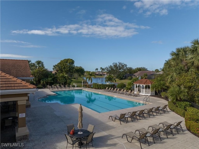 view of pool with a gazebo, a water view, and a patio