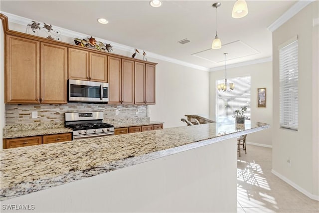 kitchen featuring ornamental molding, light tile patterned floors, tasteful backsplash, decorative light fixtures, and stainless steel appliances