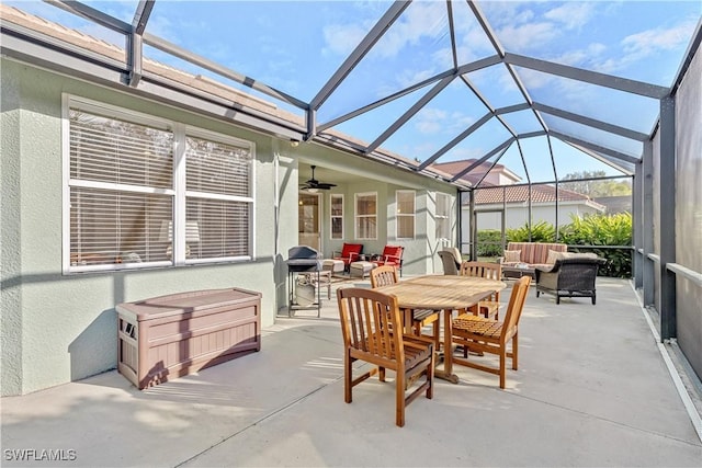 view of patio / terrace with an outdoor living space, area for grilling, and glass enclosure