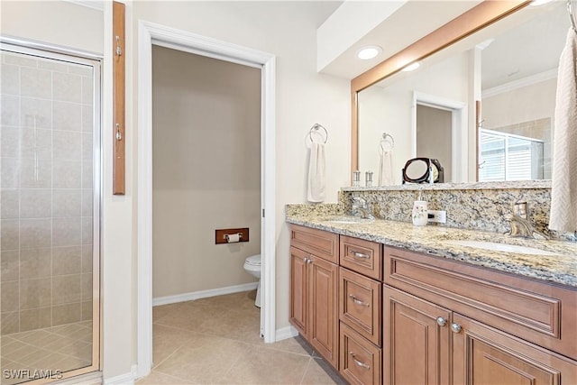 bathroom with vanity, a shower with door, crown molding, tile patterned flooring, and toilet