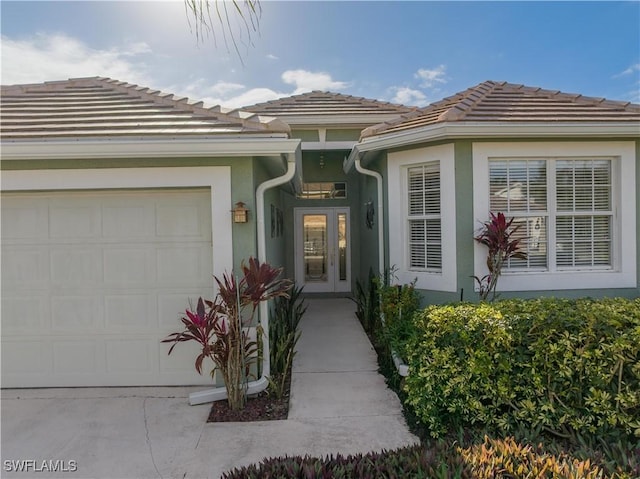 entrance to property with french doors and a garage