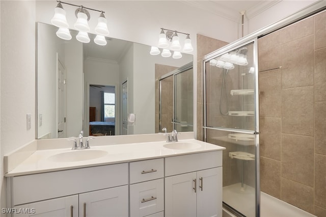 bathroom with crown molding, vanity, and an enclosed shower