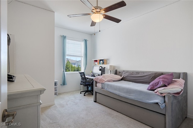 bedroom with ceiling fan and light carpet