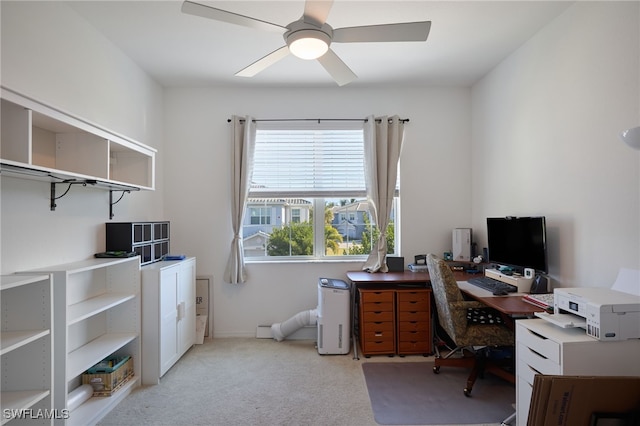 carpeted office space featuring ceiling fan