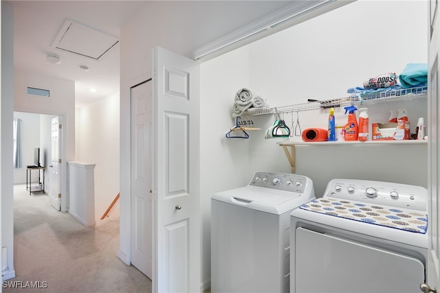 clothes washing area with separate washer and dryer and light carpet