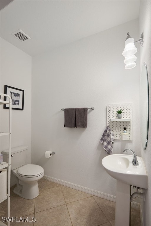 bathroom featuring tile patterned flooring and toilet