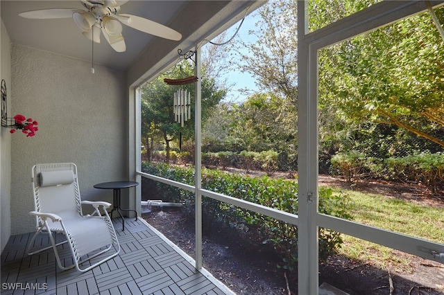 unfurnished sunroom with ceiling fan and a healthy amount of sunlight