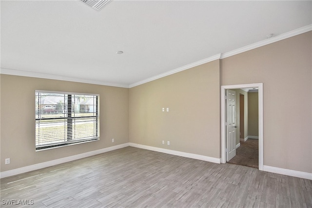 spare room featuring light hardwood / wood-style floors and ornamental molding