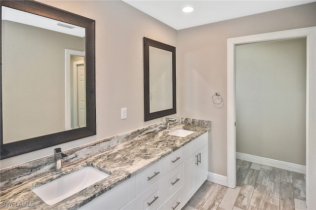 bathroom featuring vanity and hardwood / wood-style flooring