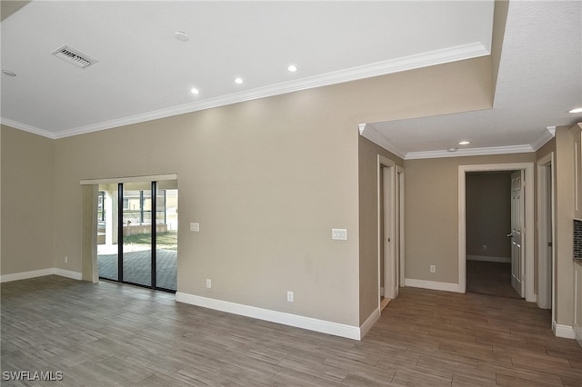 spare room with light hardwood / wood-style floors and crown molding