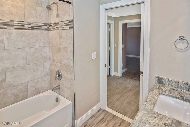 bathroom with vanity and tiled shower / bath combo