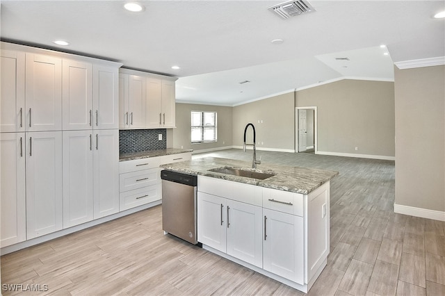 kitchen featuring white cabinets, sink, dishwasher, light hardwood / wood-style floors, and lofted ceiling