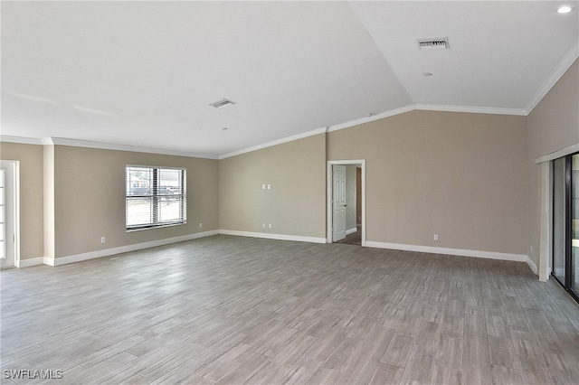 unfurnished living room with light hardwood / wood-style floors, crown molding, and vaulted ceiling