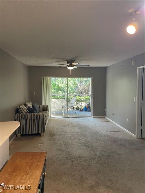 carpeted living room featuring ceiling fan