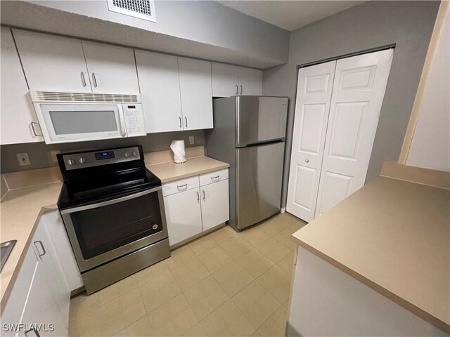 kitchen featuring white cabinetry and stainless steel appliances