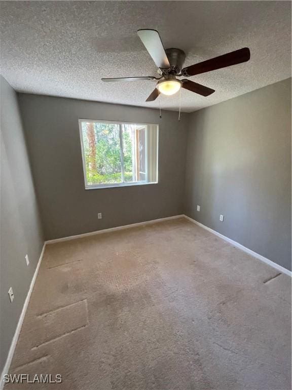 empty room featuring carpet flooring, ceiling fan, and a textured ceiling