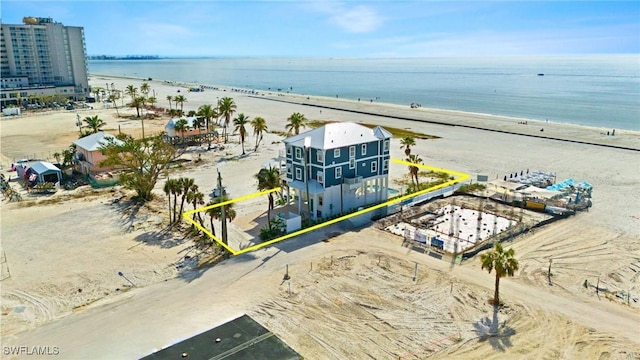 birds eye view of property featuring a water view and a view of the beach