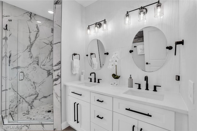 full bath with double vanity, a sink, and a marble finish shower