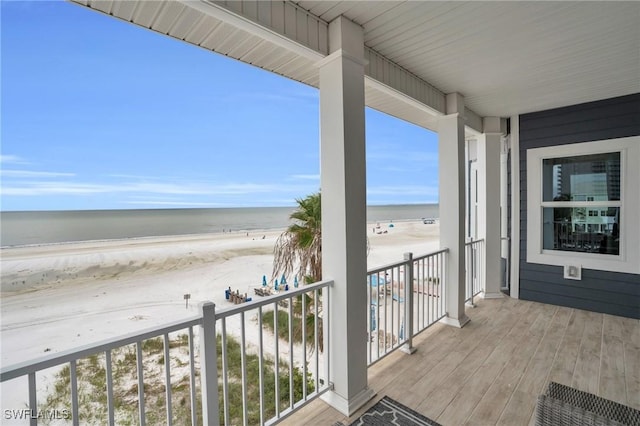 balcony featuring a water view and a beach view