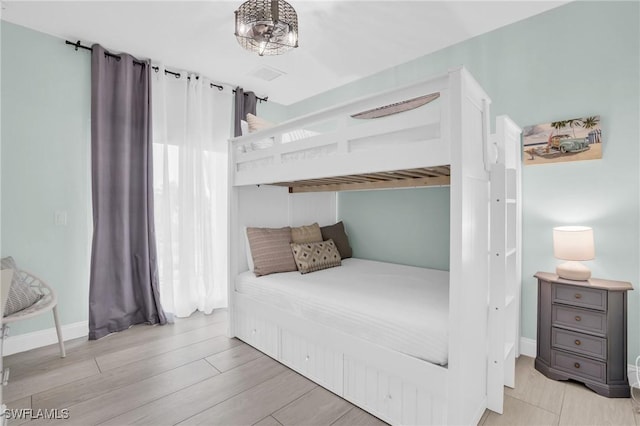 bedroom featuring light wood-type flooring and baseboards