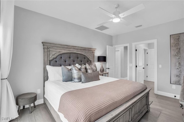 bedroom with a ceiling fan, light wood-style flooring, visible vents, and baseboards