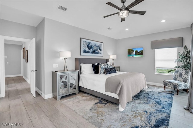 bedroom featuring light wood finished floors, recessed lighting, visible vents, and baseboards