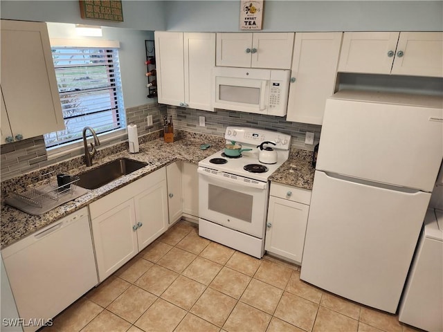 kitchen with backsplash, white cabinetry, white appliances, and sink