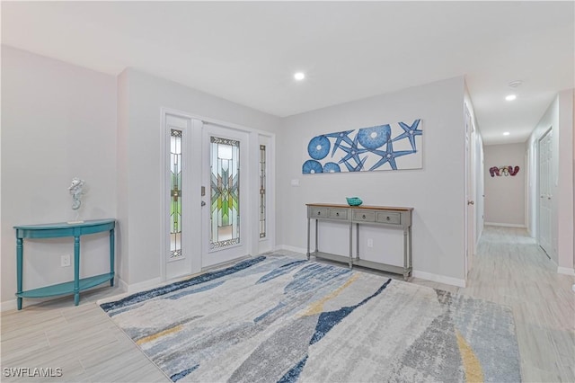 foyer entrance with light wood-type flooring