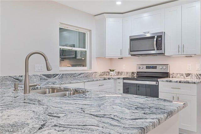 kitchen with white cabinetry and appliances with stainless steel finishes