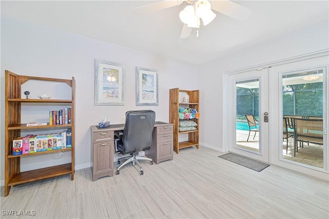 office space with plenty of natural light, ceiling fan, light hardwood / wood-style flooring, and french doors