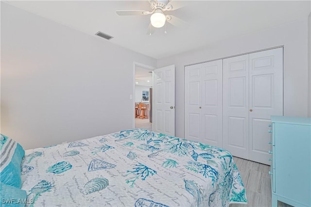 bedroom featuring ceiling fan and a closet