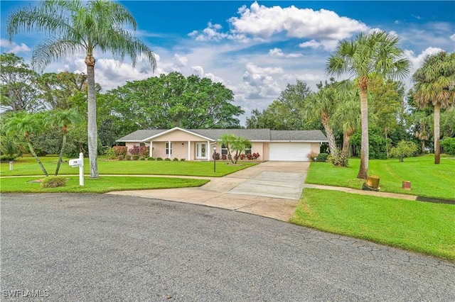 ranch-style house with a garage and a front lawn