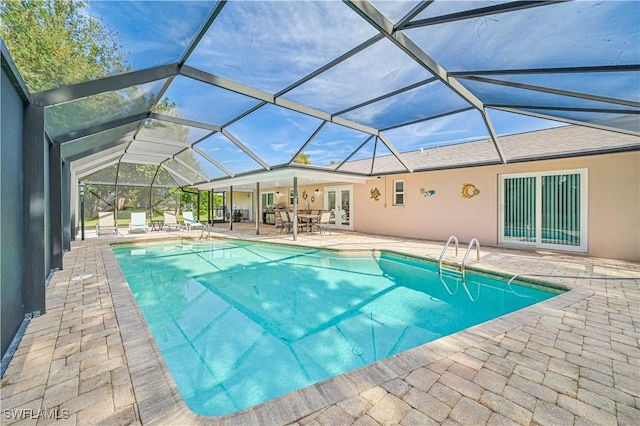 view of swimming pool featuring french doors, a patio area, and a lanai