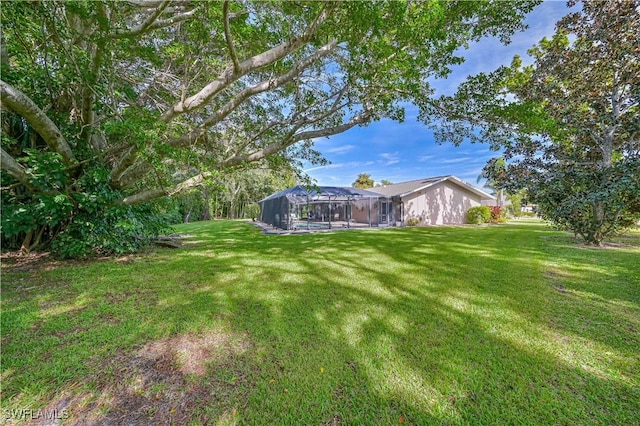 view of yard featuring a lanai