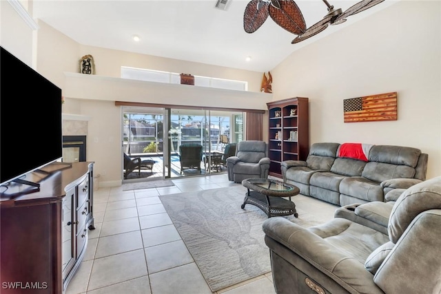 living room featuring ceiling fan, light tile patterned floors, and high vaulted ceiling