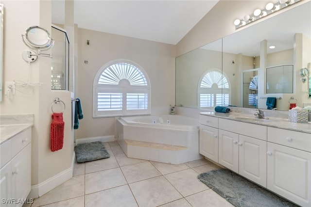 bathroom featuring vanity, plenty of natural light, plus walk in shower, and tile patterned flooring