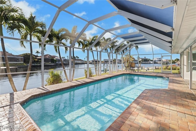 view of pool with a patio, a water view, and a lanai