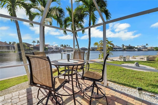 sunroom featuring a water view and a wealth of natural light