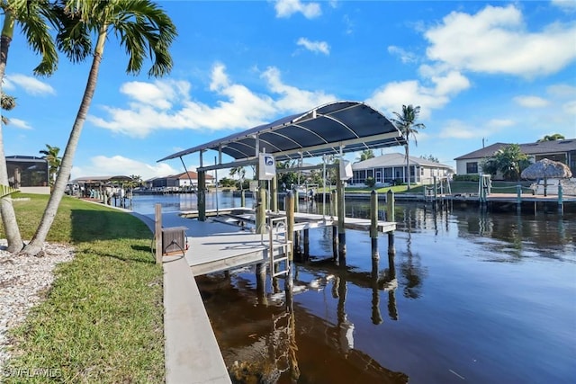 dock area featuring a lawn and a water view