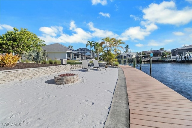 dock area featuring a water view and a fire pit