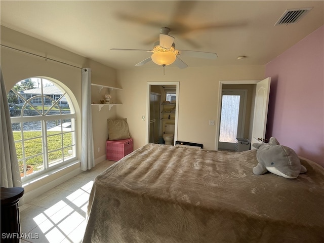 bedroom featuring connected bathroom, ceiling fan, and light tile patterned flooring