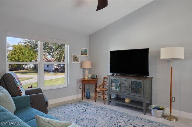 living room with ceiling fan and vaulted ceiling