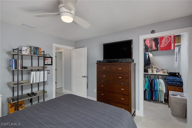 carpeted bedroom with ceiling fan and a closet