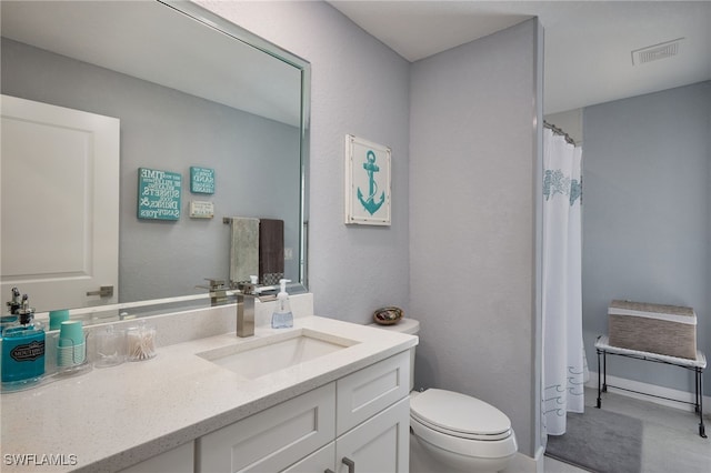 bathroom featuring vanity and toilet