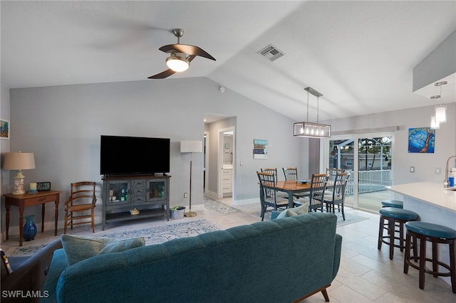 living room with vaulted ceiling, ceiling fan, and light tile patterned flooring