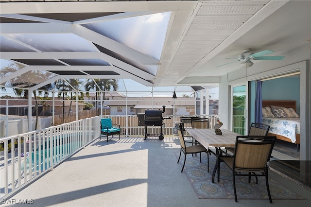 view of patio / terrace featuring a lanai, ceiling fan, and a fenced in pool