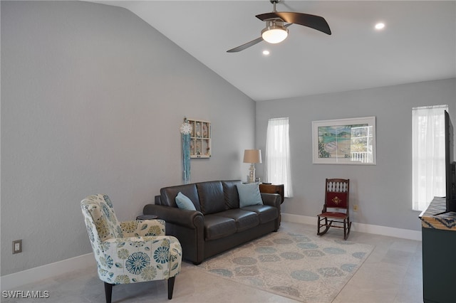 living room featuring ceiling fan, light tile patterned flooring, and lofted ceiling